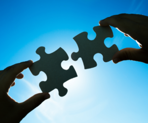 Two connecting jigsaw pieces to exemplify two people having a one-to-one networking meeting