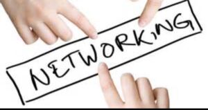 Image of fingers pointing to a networking sign to indicate networking groups are good for referrals