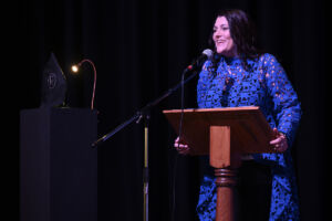 Rossendale Business Awards MC Tracy Heatley smiling as she addresses the audience