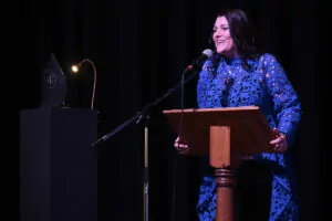 Rossendale Business Awards MC Tracy Heatley smiling as she addresses the audience
