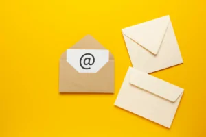 Envelopes on a yellow background to indicate the newsletter and email marketing elements of successful small business marketing campaigns